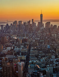 Aerial view of buildings in city during sunset