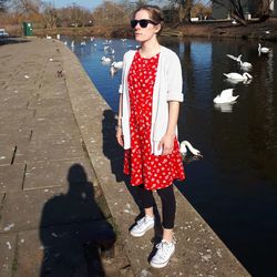 Full length of woman standing against lake