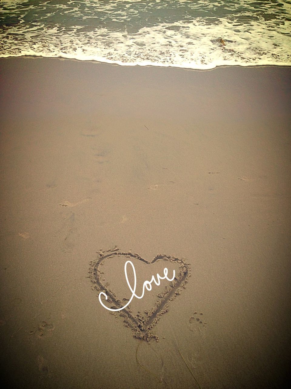 text, western script, communication, sand, high angle view, heart shape, footprint, beach, capital letter, love, creativity, ideas, art, close-up, message, art and craft, textured, no people, shore, day