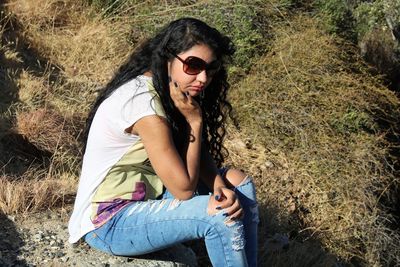 Young woman sitting on field