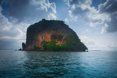 Rock formation in sea against sky