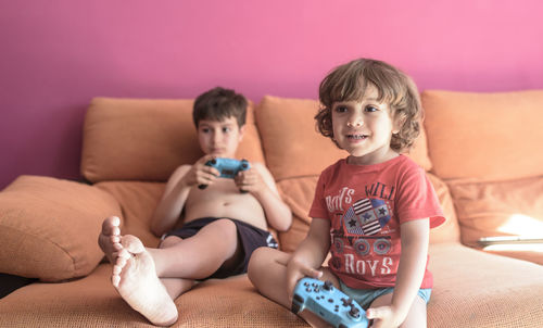 Two little boys having lots of fun with video games.