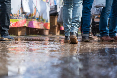 Low section of people walking on street