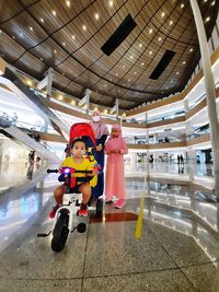 Low angle view of people in shopping mall