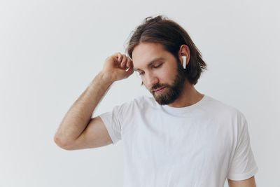 Young man standing against white background