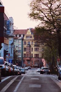 Cars on road along buildings