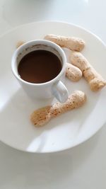 High angle view of coffee and cookies on table