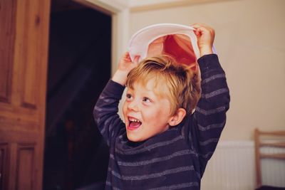 Cute boy wearing hat at home