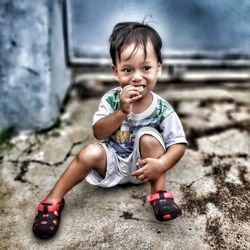 Portrait of cute girl sitting on floor