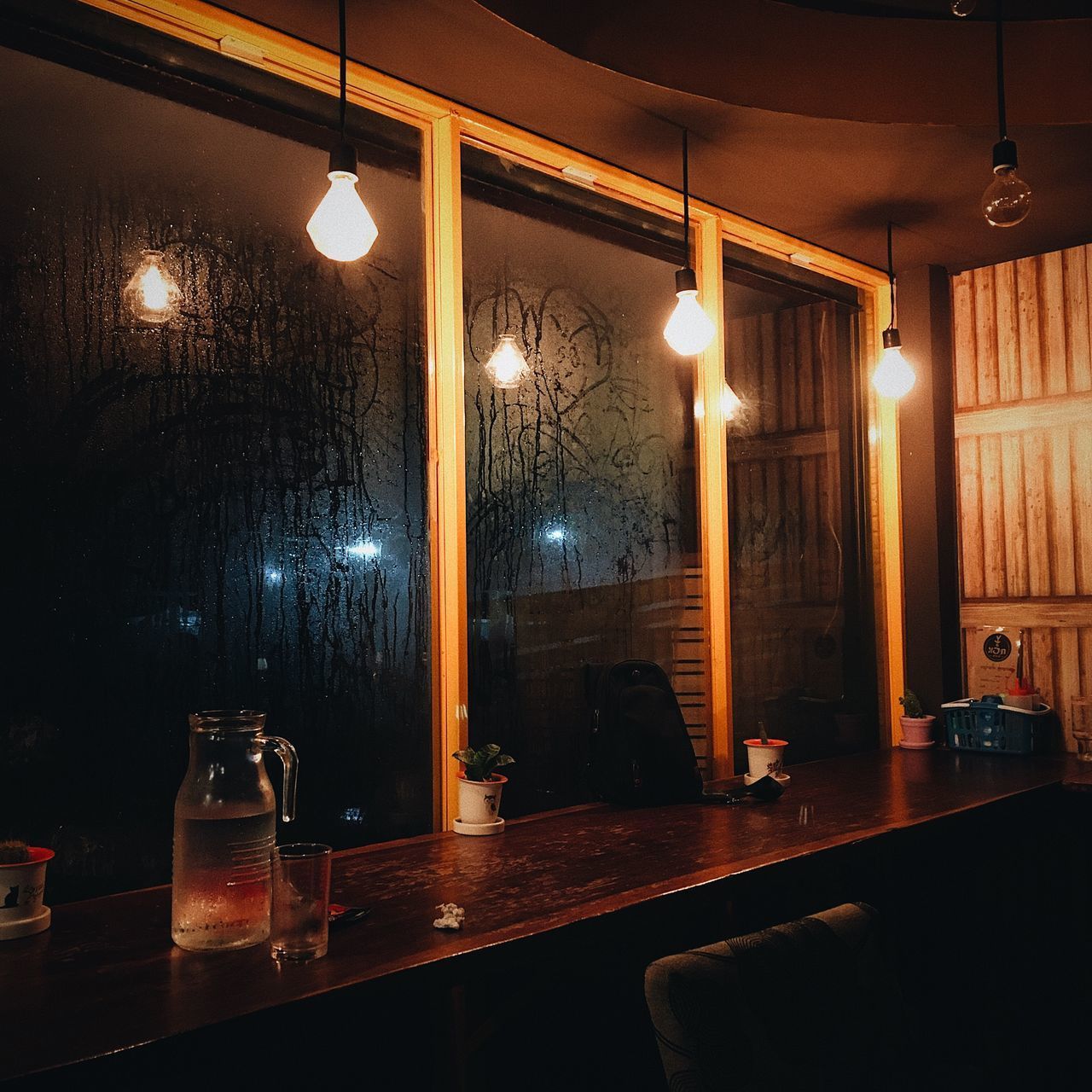 ILLUMINATED LIGHT BULBS IN RESTAURANT AT NIGHT