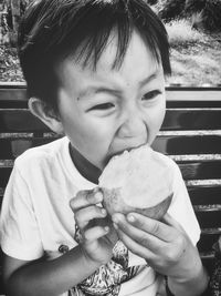 Close-up of boy eating fruit outdoors