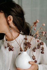 Portrait of woman holding flower