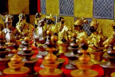 Close-up of statues on chess board