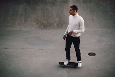 High angle view of young man skateboarding at park