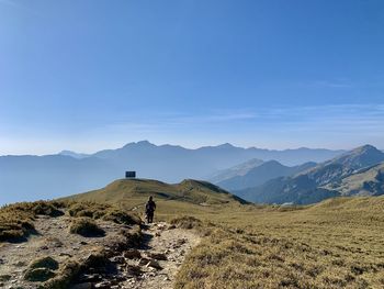 Scenic view of mountains against blue sky