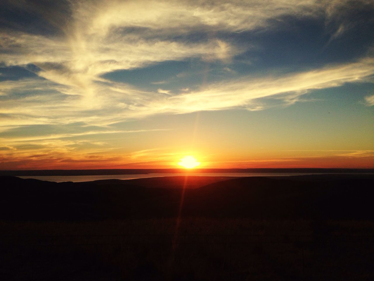 sunset, sun, silhouette, scenics, tranquil scene, tranquility, beauty in nature, orange color, sky, idyllic, nature, landscape, sunlight, cloud - sky, sunbeam, cloud, dark, outdoors, majestic, dramatic sky