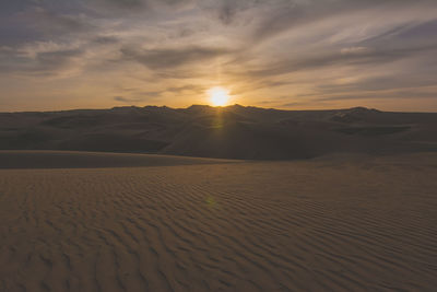 Rippled sand and sand dunes at dusk