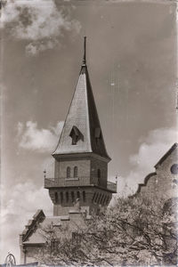 Low angle view of tower and building against sky