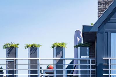 Low angle view of buildings against clear blue sky