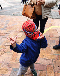 High angle view of boy on footpath by street