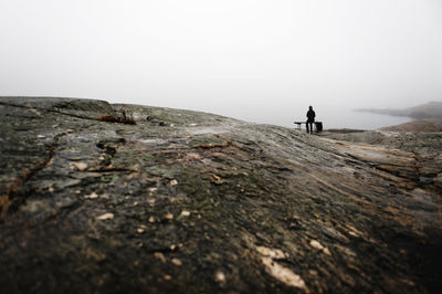 Person on bench looking away