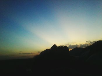 Silhouette of mountain against sky at sunset