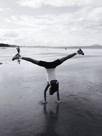 Woman jumping on beach