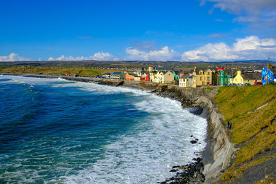 Scenic view of beach against blue sky