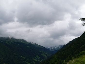 Scenic view of mountains against cloudy sky