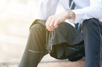 Midsection of man sitting at home