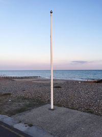 Scenic view of calm beach against sky