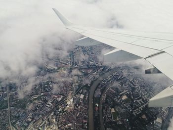 High angle view of airplane flying over paris