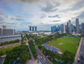 View of cityscape against cloudy sky