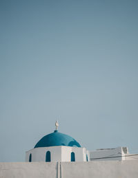 Low angle view of church dome against clear blue sky