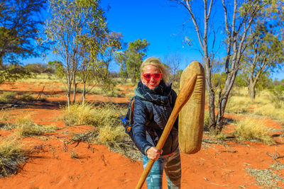 Portrait of smiling woman standing on land