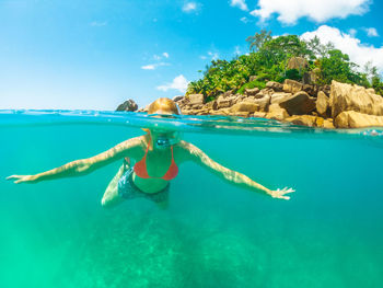 Full length of woman snorkeling in sea during summer