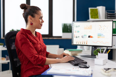 Businesswoman using computer at office