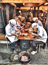 People sitting at market stall