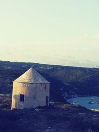 Built structure on landscape against sky