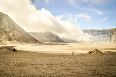 Person on field at mt bromo against sky