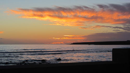 Scenic view of calm sea at sunset