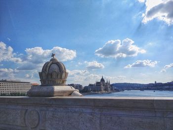 Statue against sky in city