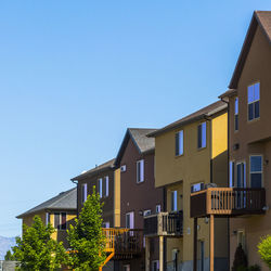 Low angle view of buildings in town against sky