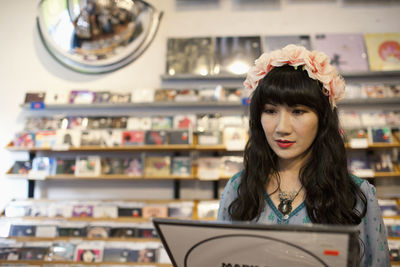 Young woman browsing albums in a record store