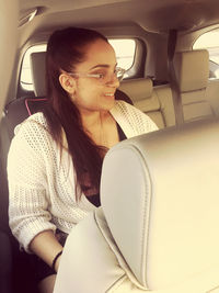 Mid adult woman sitting in car