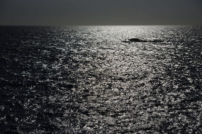 Scenic view of sea against clear sky at night