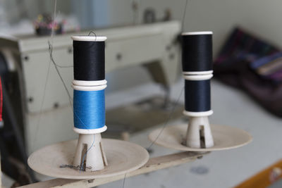 Close-up of thread spools on container