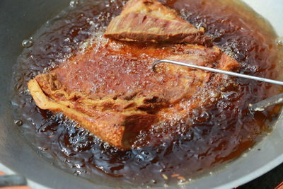 Close-up of meat in frying pan