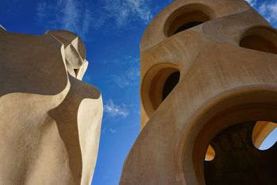 Low angle view of sculpture on building against sky