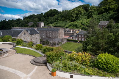 High angle view of trees and buildings against sky